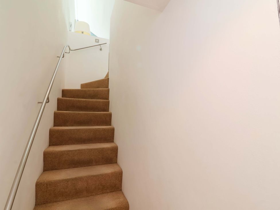 A staircase with carpet and a handrail at 12 Nautilus in Westward Ho!
