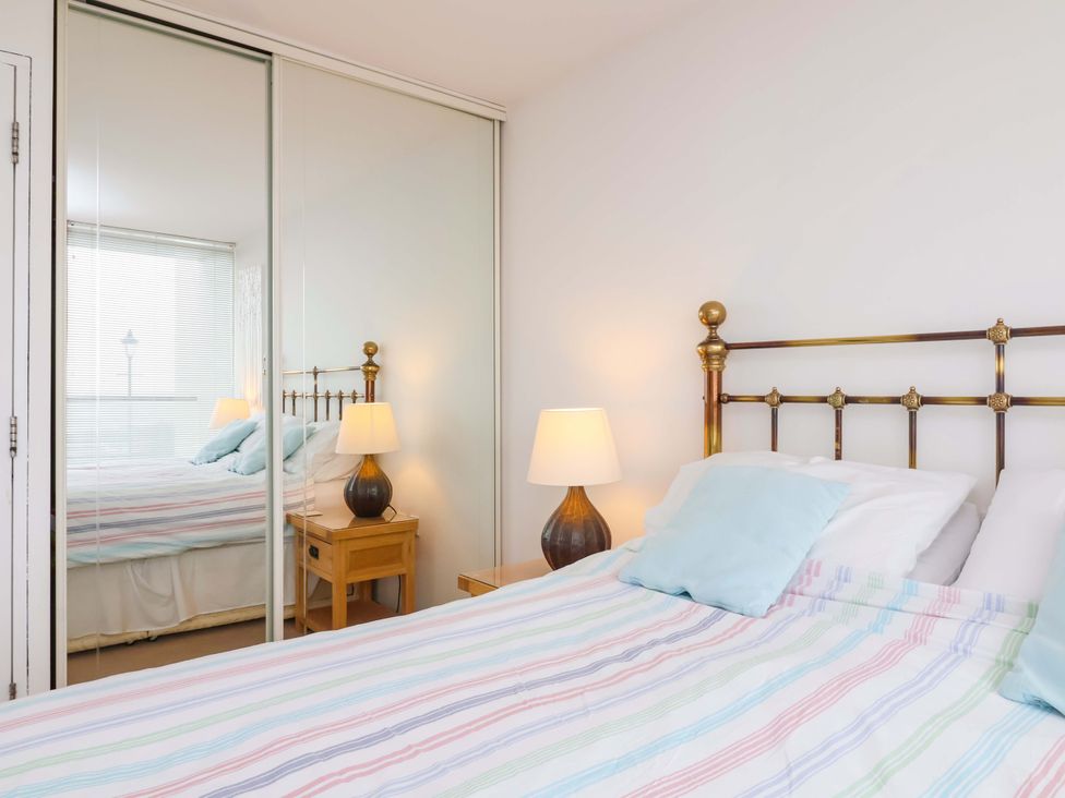 A bedroom with a bed and bedside table at 12 Nautilus in Westward Ho!