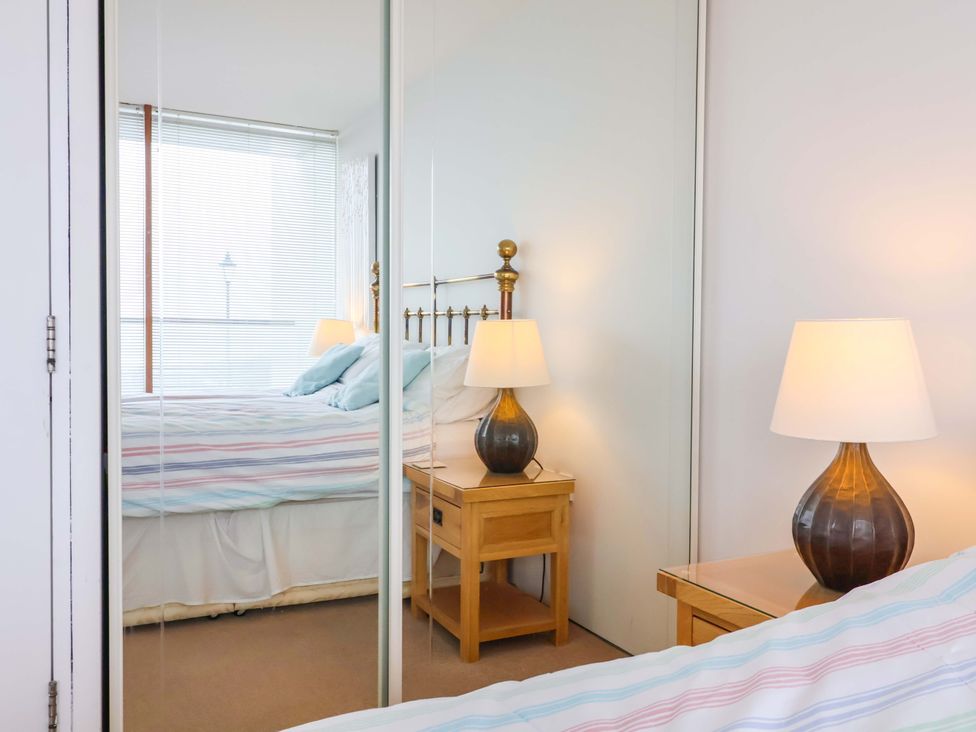 A bedroom with a bed and bedside table at 12 Nautilus in Westward Ho!