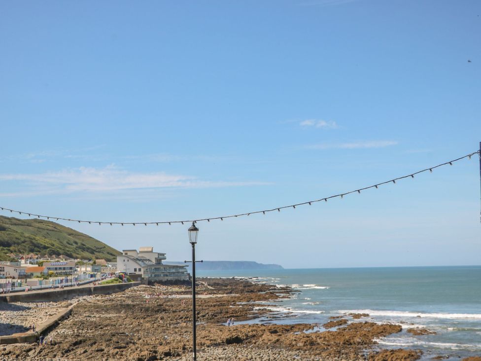 A coastal view with buildings and rocks at 12 Nautilus in Westward Ho!
