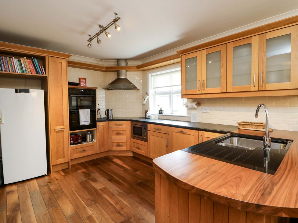 A kitchen with cabinets and appliances at Sunnyside River Chapel