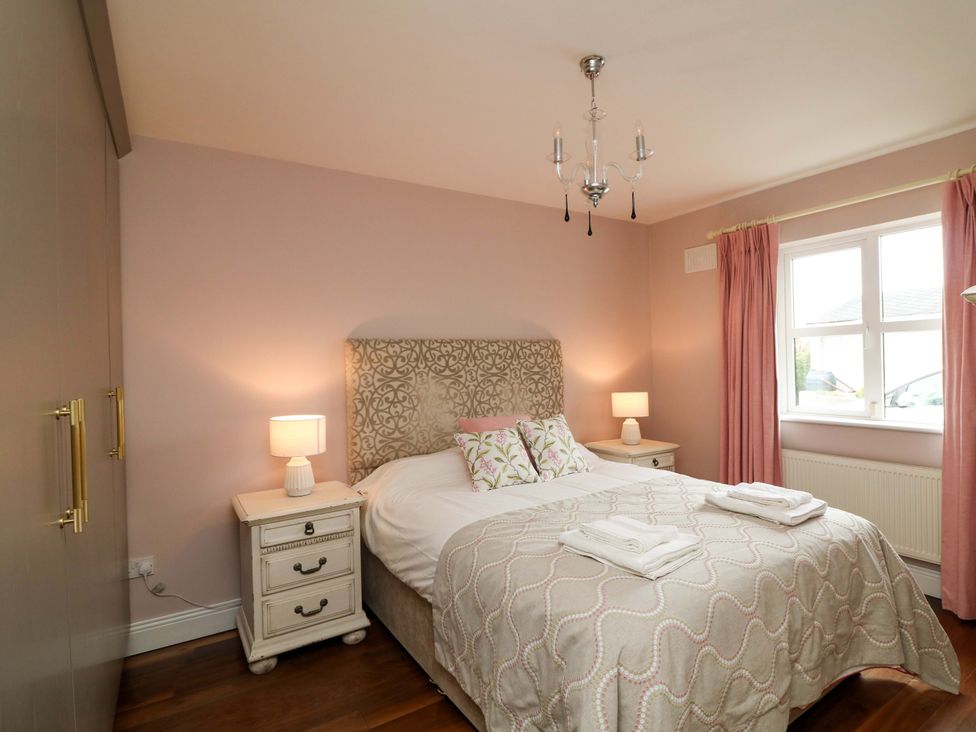 A bedroom with a bed and bedside tables at Sunnyside in River Chapel