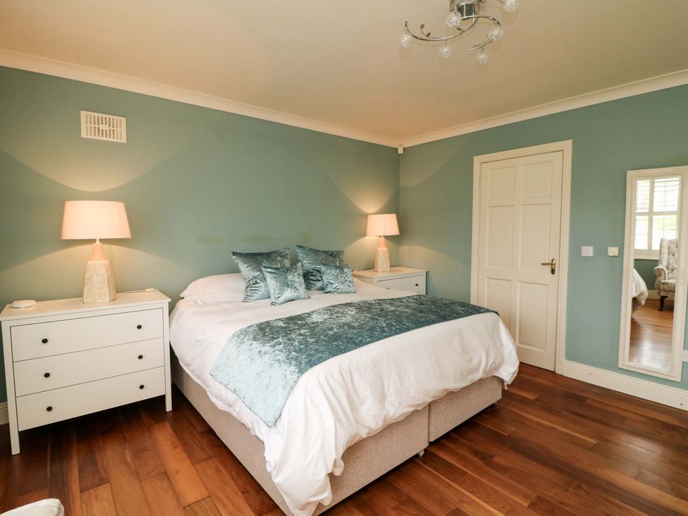 A bedroom with a bed and nightstands at Sunnyside in River Chapel