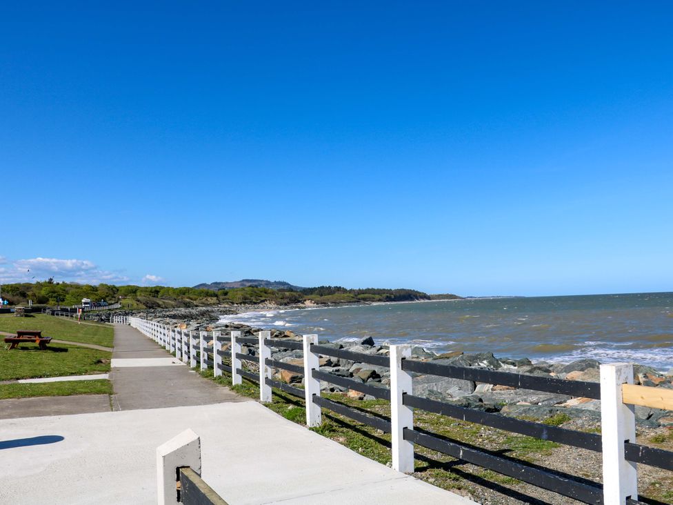 A coastal path beside rocks and ocean at Sunnyside River Chapel