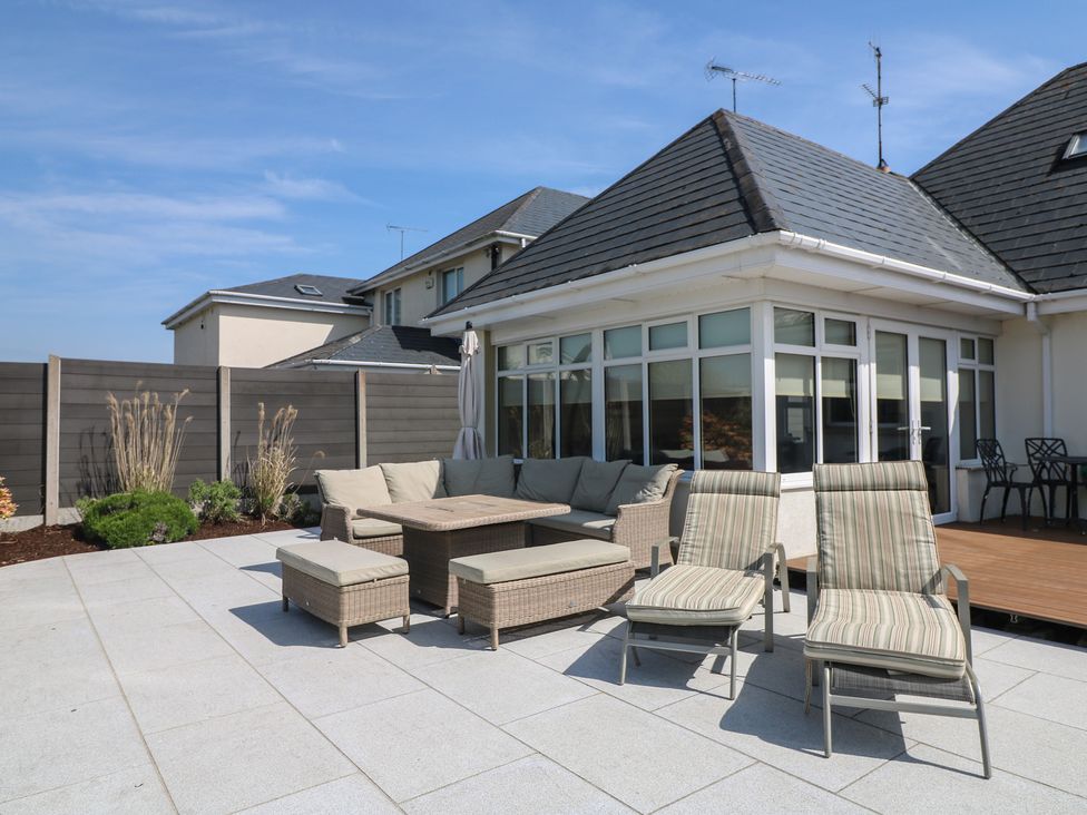 A garden area with seating and loungers at Sunnyside, River Chapel near Courtown, County Wexford