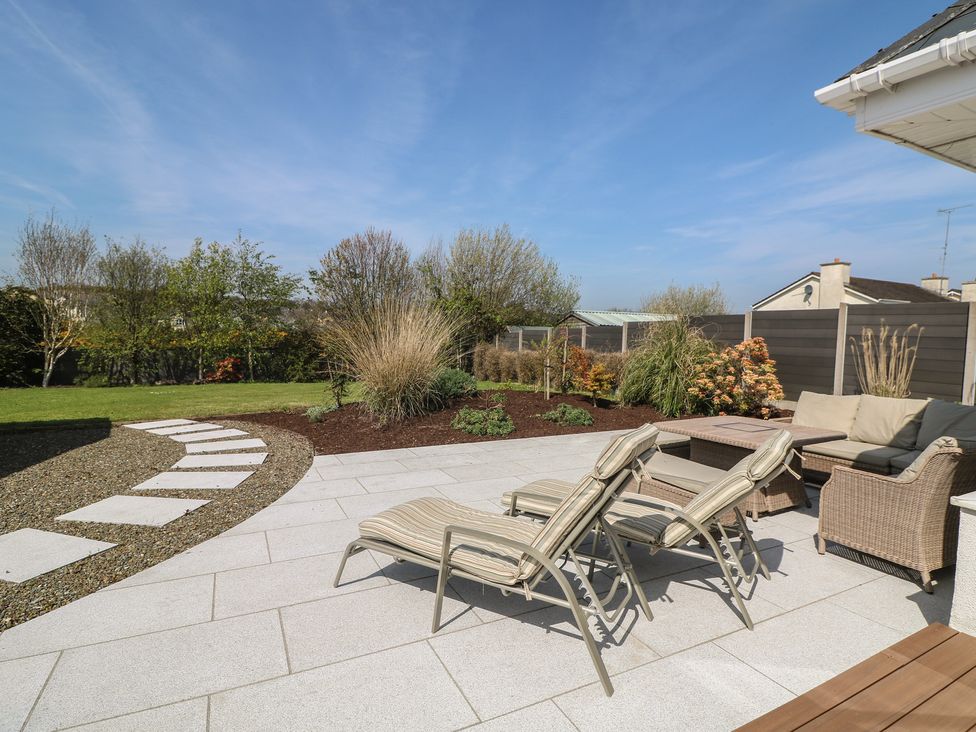 A garden with seating area and pathway at Sunnyside, River Chapel near Courtown, County Wexford