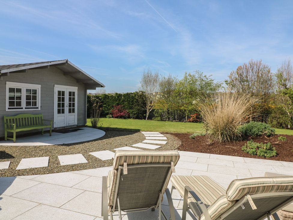 A garden with a shed and seating area at Sunnyside River Chapel near Courtown, County Wexford