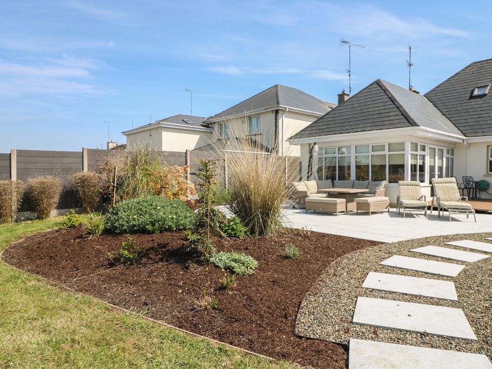 A garden with patio and deck chairs at Sunnyside River Chapel near Courtown, County Wexford