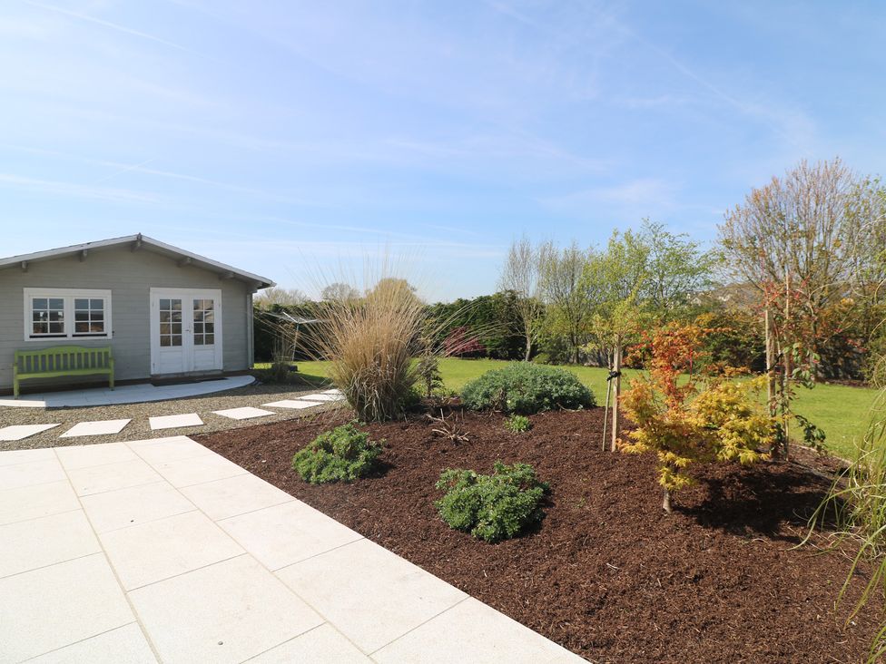 A garden with a shed and a bench at Sunnyside, River Chapel near Courtown, County Wexford