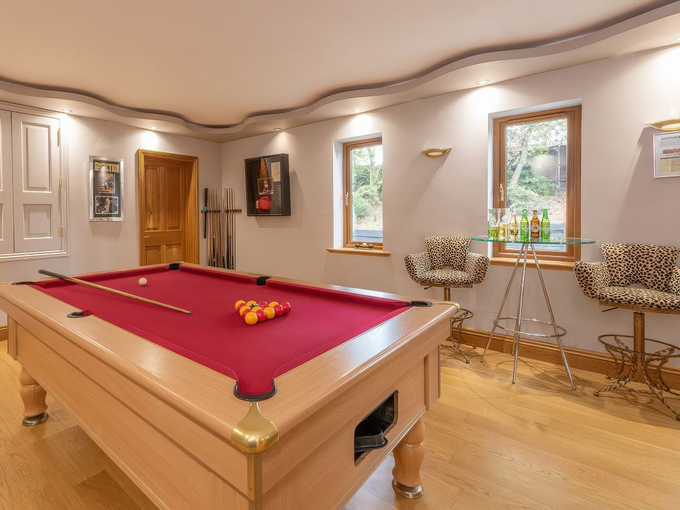A game room with a pool table and bar stools at Hamble House in Southampton