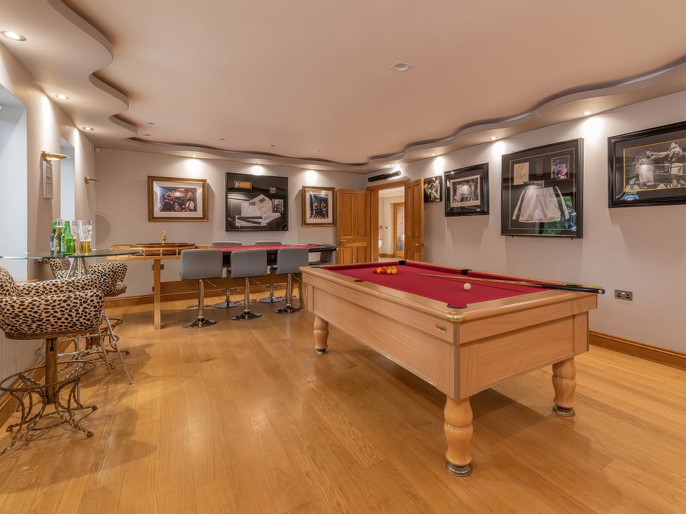 A games room with a pool table and bar counter at Hamble House Southampton
