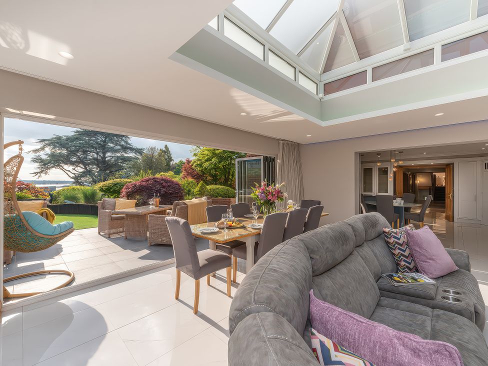 A living room with a sofa and dining table at Hamble House in Southampton