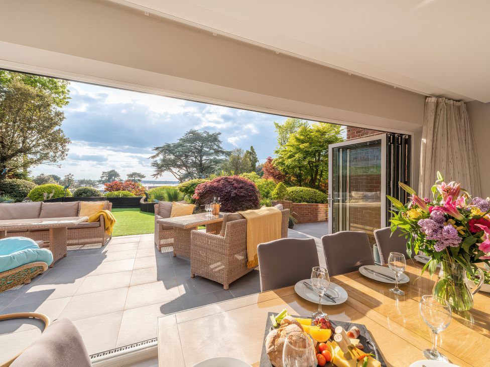 A dining room with a view of the garden at Hamble House in Southampton