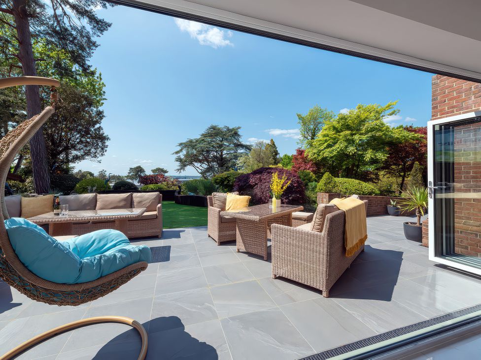 An outdoor seating area with a sofa and coffee table at Hamble House in Southampton