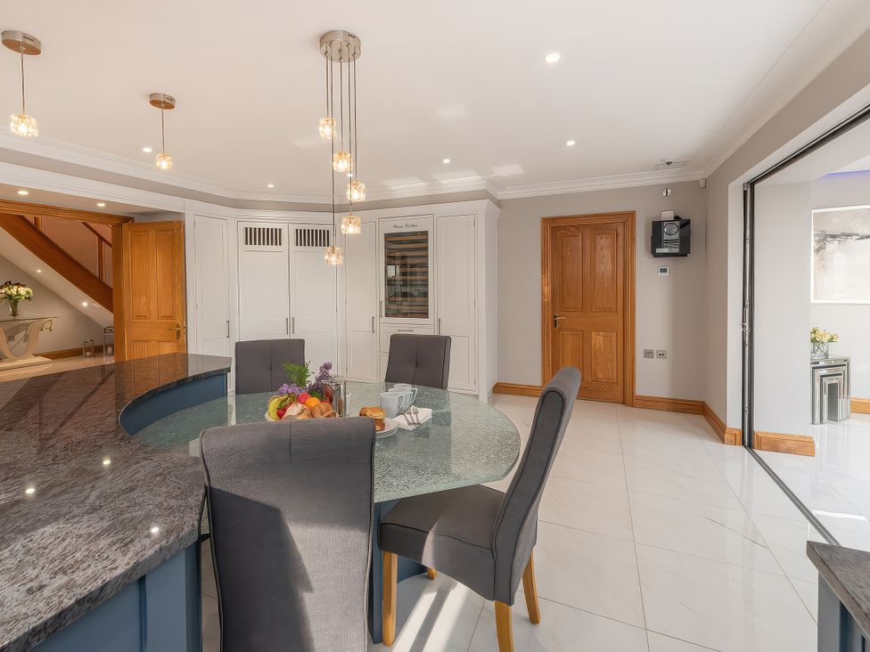 A kitchen with a dining table and chairs at Hamble House in Southampton
