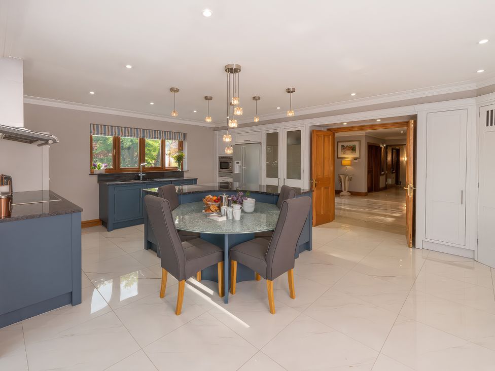 A kitchen with a dining table and chairs at Hamble House in Southampton
