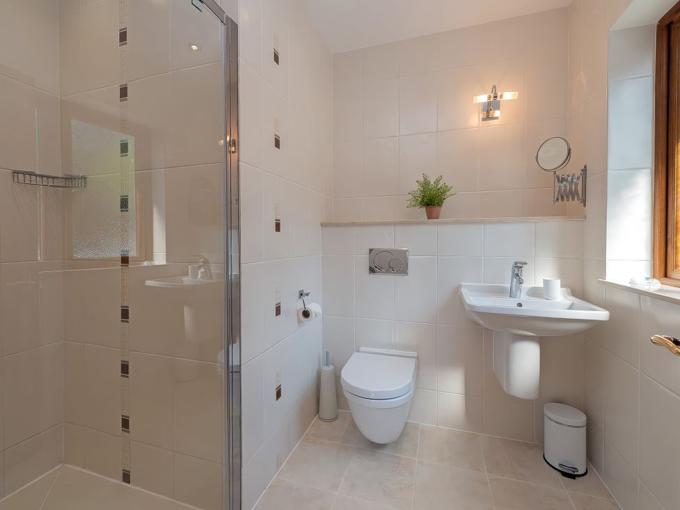 A bathroom with a shower, toilet, and sink at Hamble House in Southampton