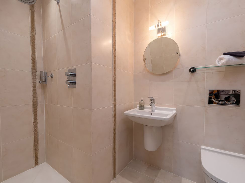 A bathroom with shower, wash basin and towel rack at Hamble House Southampton