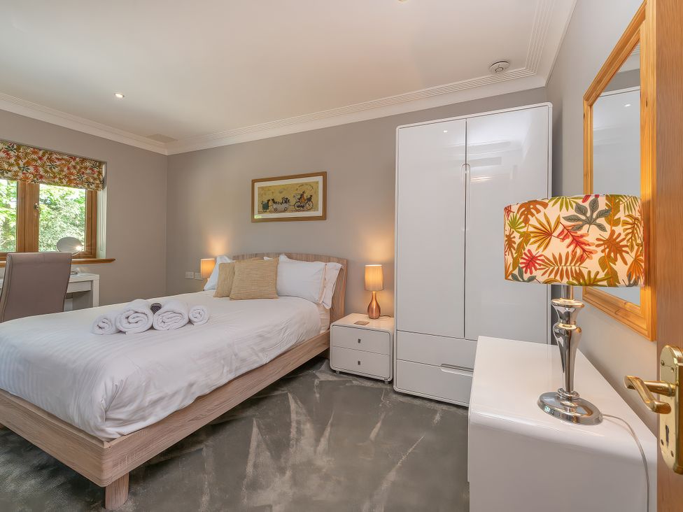 A bedroom with a bed and a desk at Hamble House in Southampton