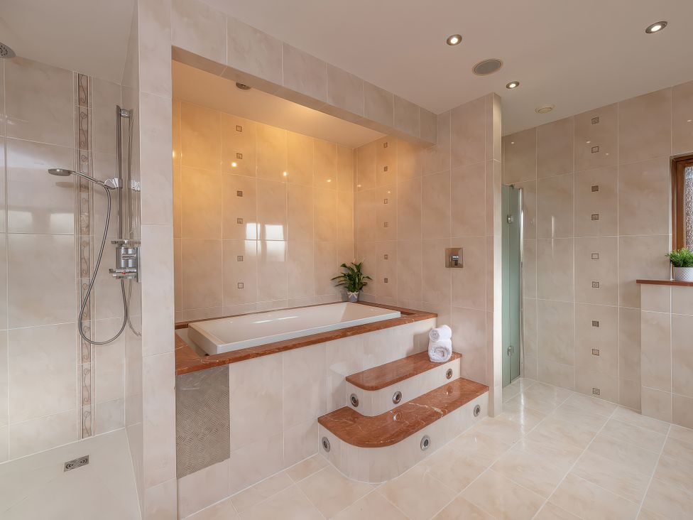 A bathroom with a bathtub and shower at Hamble House Southampton