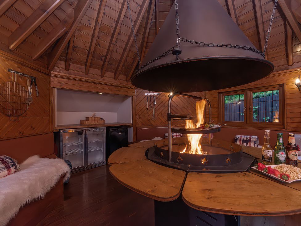 A gathering area with a fire pit and benches at Hamble House in Southampton