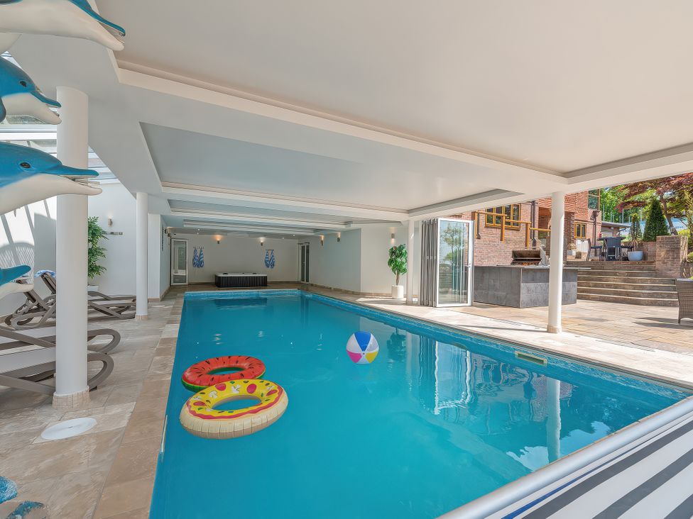 An indoor pool with decorations and pool toys at Hamble House in Southampton