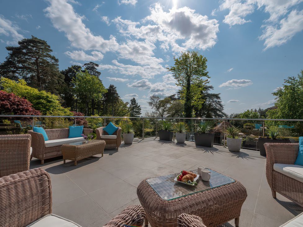 An outdoor patio with seating and planters at Hamble House in Southampton