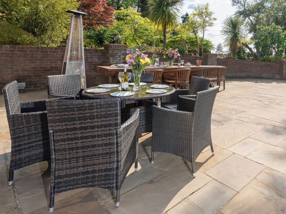 A dining area with a table and chairs in an outdoor setting at Hamble House Southampton