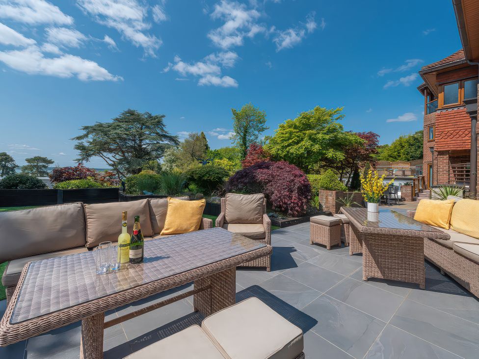 A patio area with seating and drinks at Hamble House Southampton