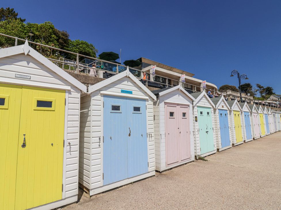 A row of beach huts with colorful doors at Le Petit Glen in Uplyme