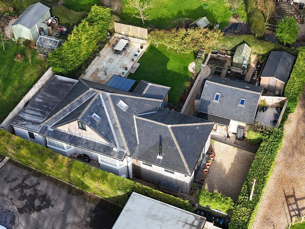 An aerial view of a property with gardens and structures at Le Petit Glen in Uplyme