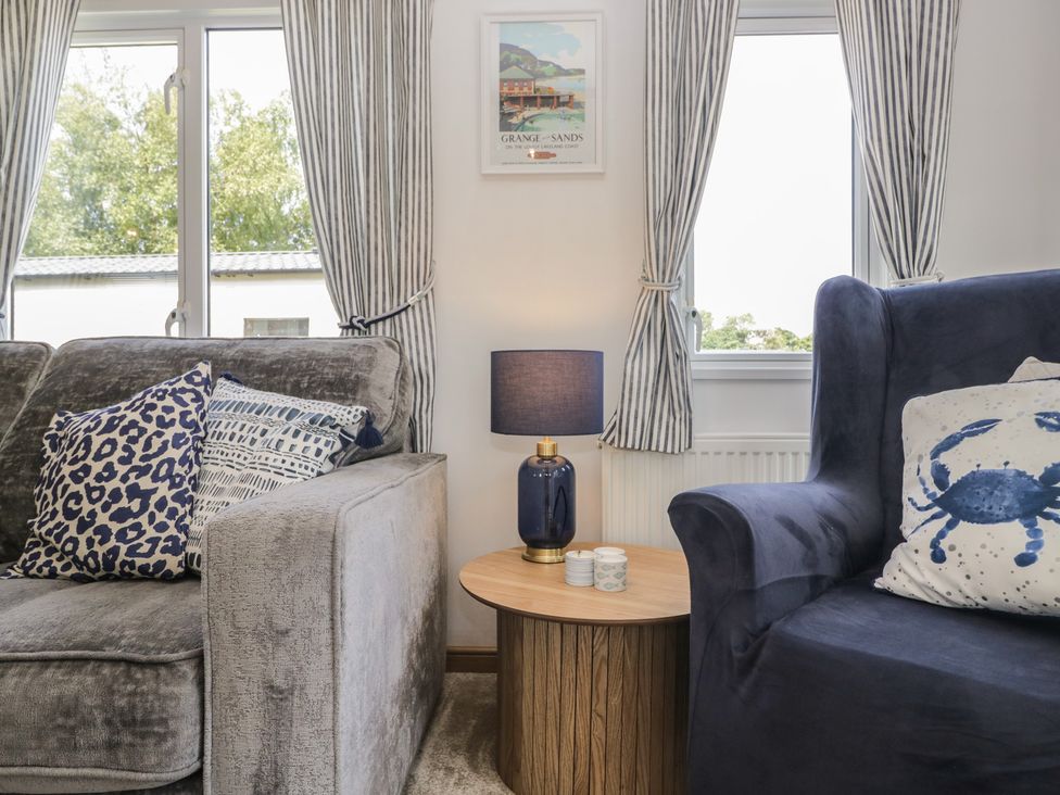 A living room with a sofa and side table at Hedgerow Lodge near Haven Lakeside Grange-Over-Sands