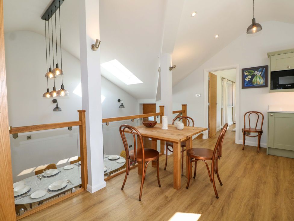 A dining room with a table and chairs at Keepers Cottage in Petersfield