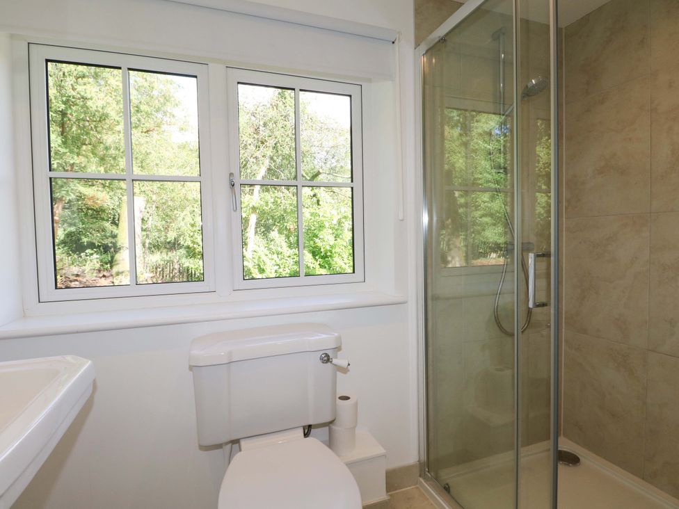 A bathroom with a toilet and shower at Keepers Cottage in Petersfield