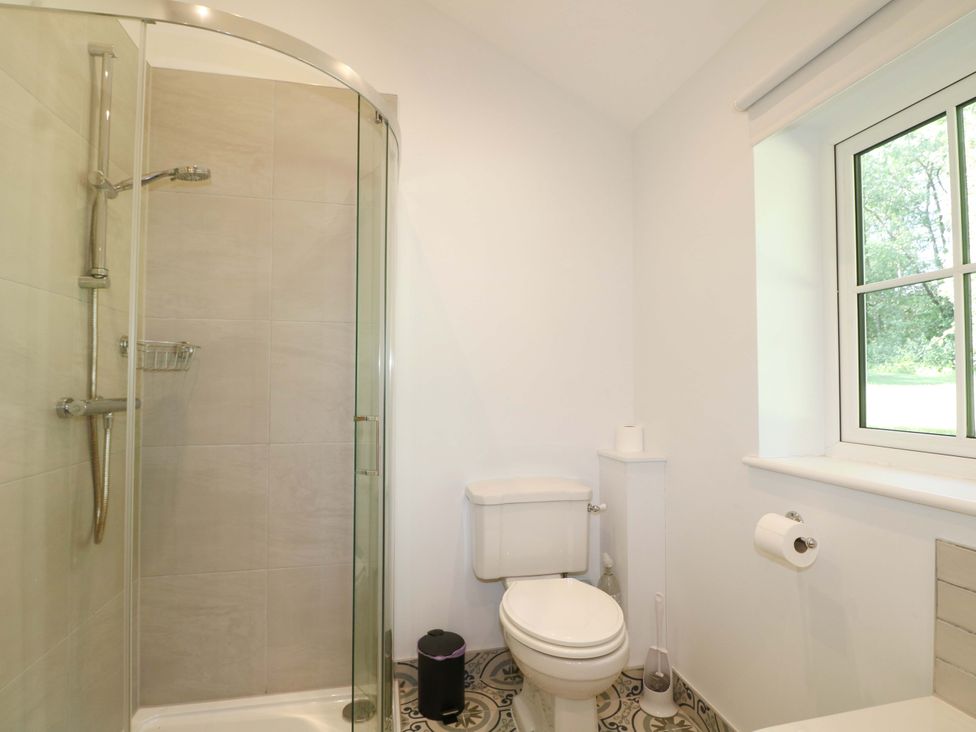 A bathroom with a shower and toilet at Keepers Cottage in Petersfield