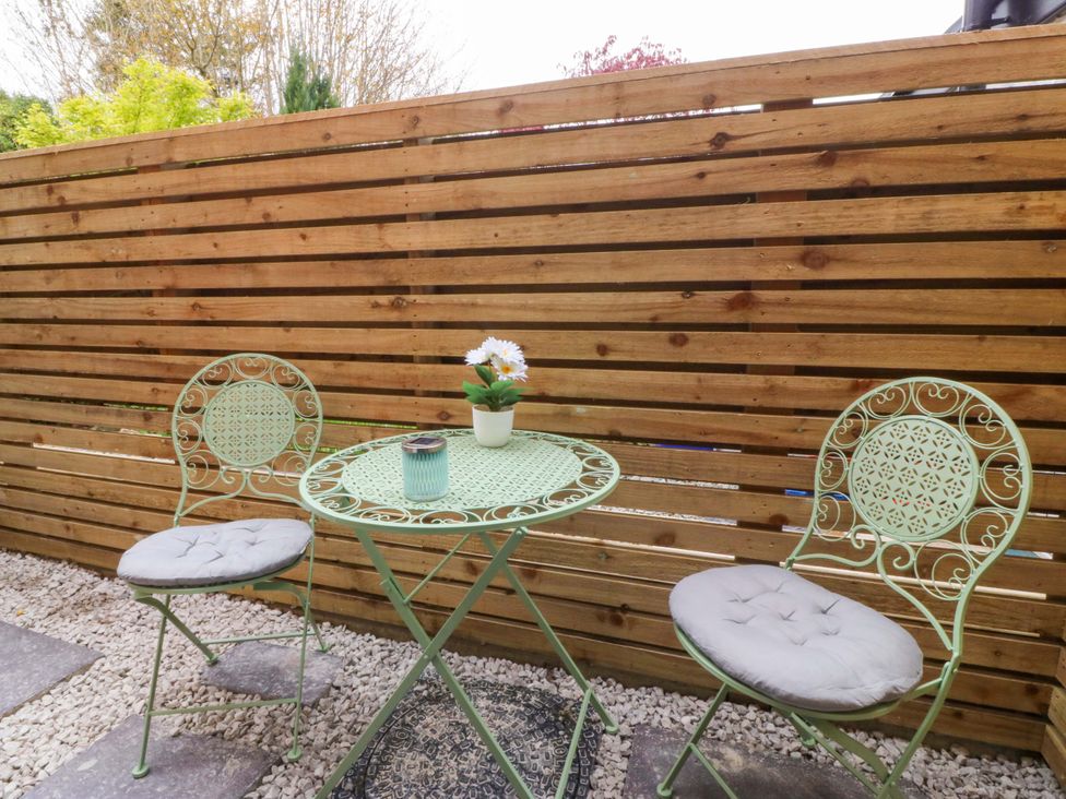 An outdoor seating area with a table and two chairs at Trwyn Cam Brynrefail near Llanberis