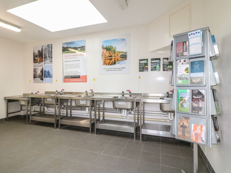 A wash area with sinks and information display at Sherwood - Cosy Pod 6 Mansfield