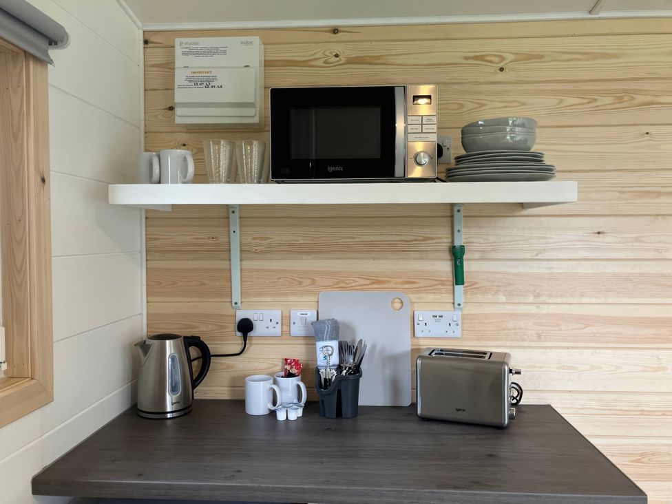 A kitchen with a microwave, kettle, and plates at Sherwood - Cosy Pod 6 Mansfield