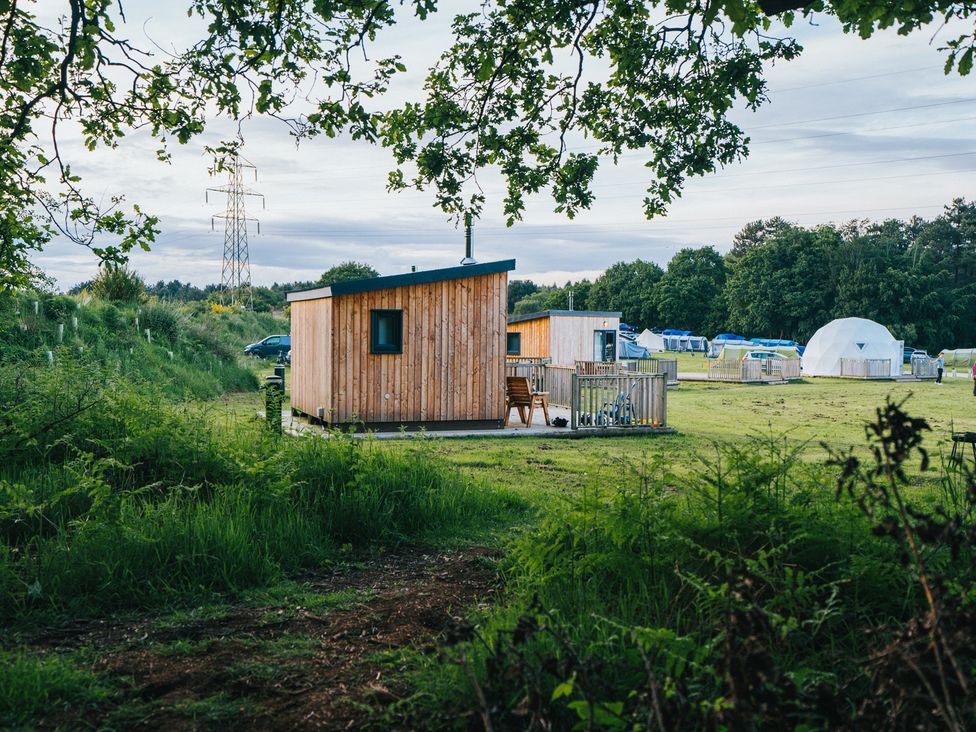A wooden cabin with deck and tents at Sherwood - Cosy Pod 6 Mansfield