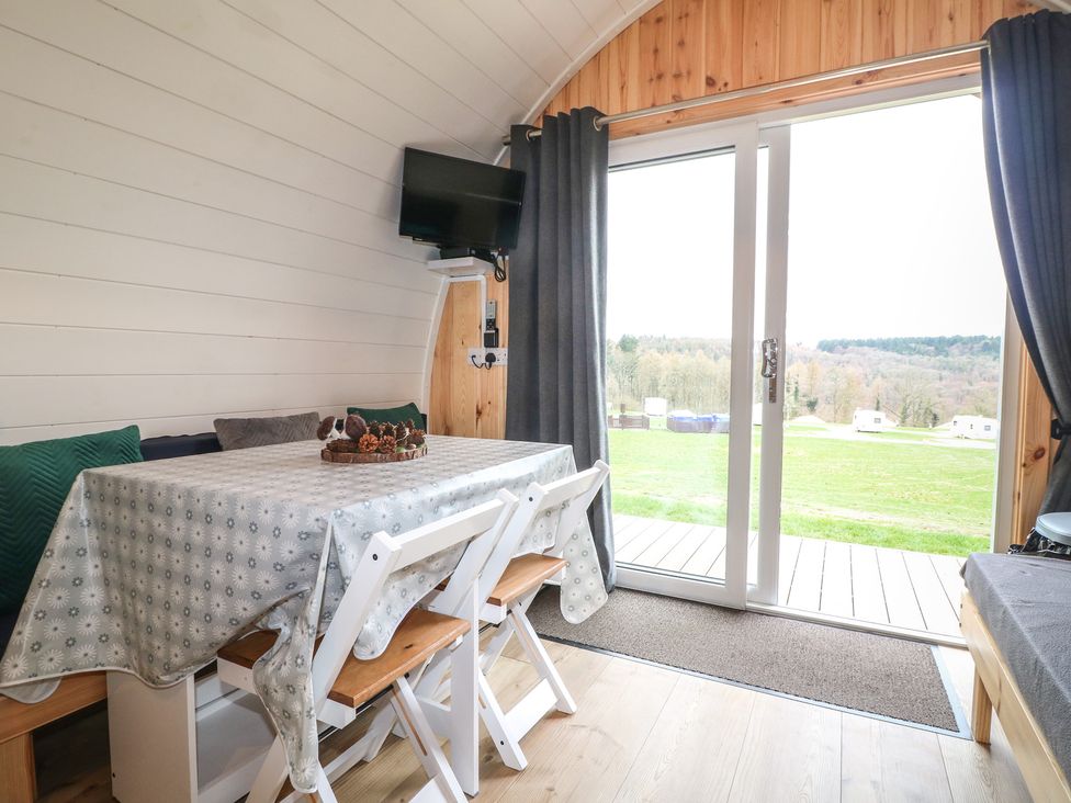 A dining area with table and chairs at Bracelands - Deluxe Pod 6 in Coleford