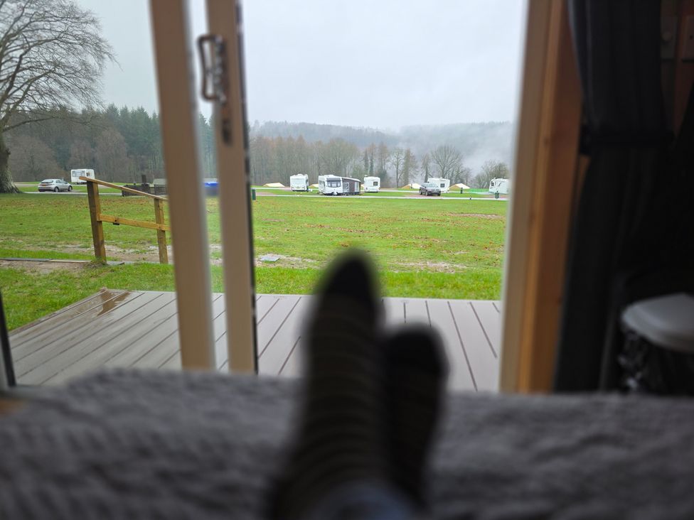 A view of caravans parked in a grassy area at Bracelands - Deluxe Pod 8 in Coleford