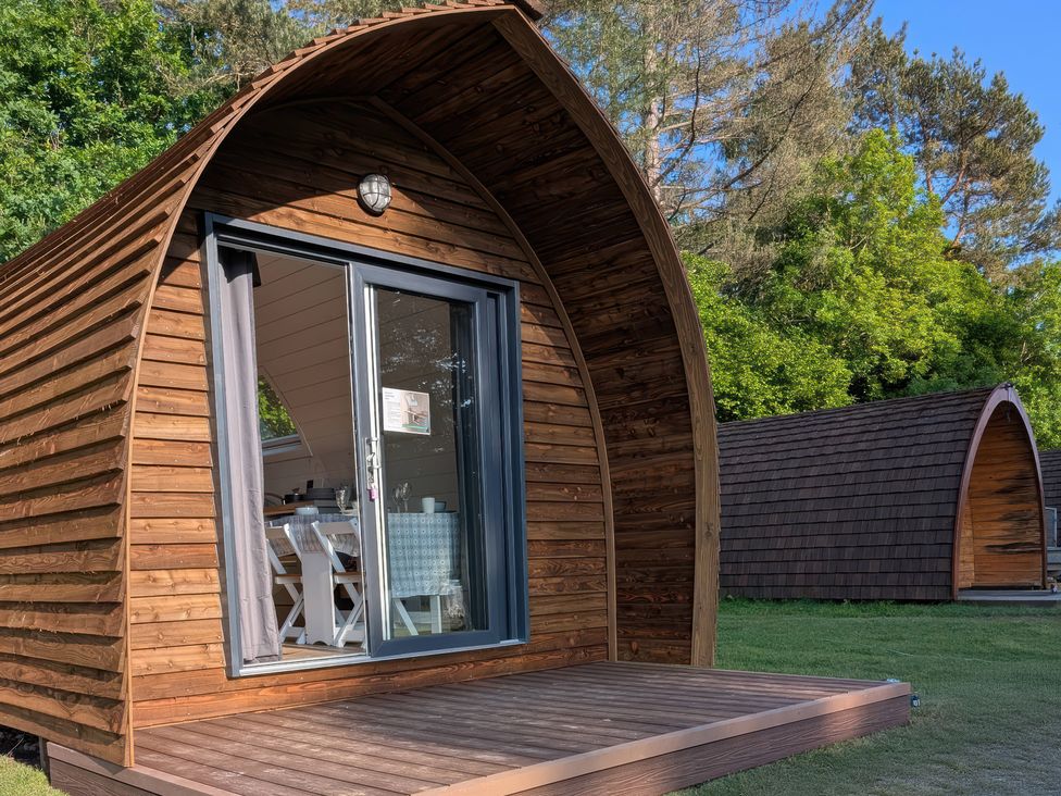 A lodging pod with a deck and furniture at Bracelands - Deluxe Pod 8 Coleford