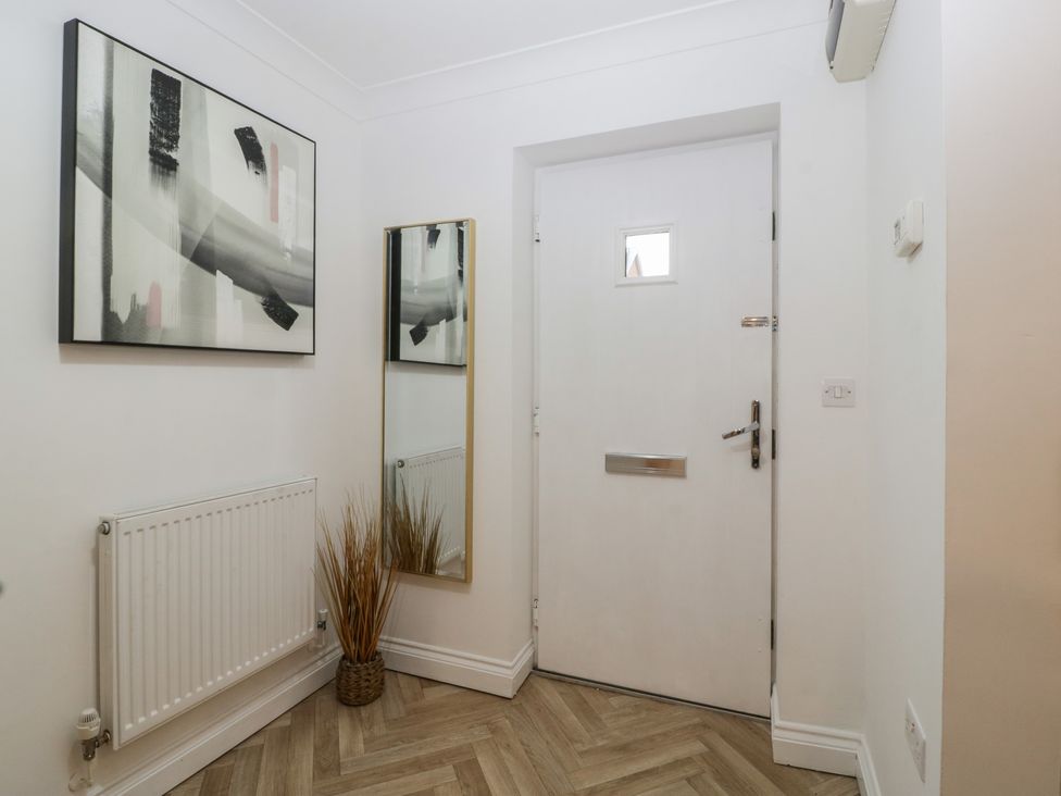 A hallway with wall art and a mirror at 42 Ynys Y Nos Glynneath