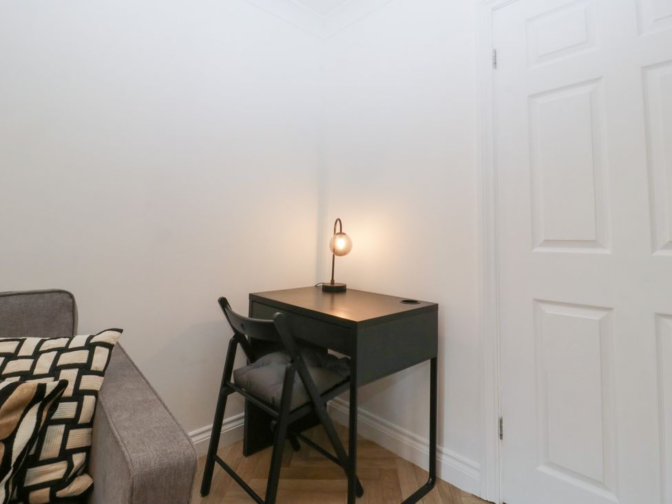 An office area with a desk and a lamp at 42 Ynys Y Nos in Glynneath