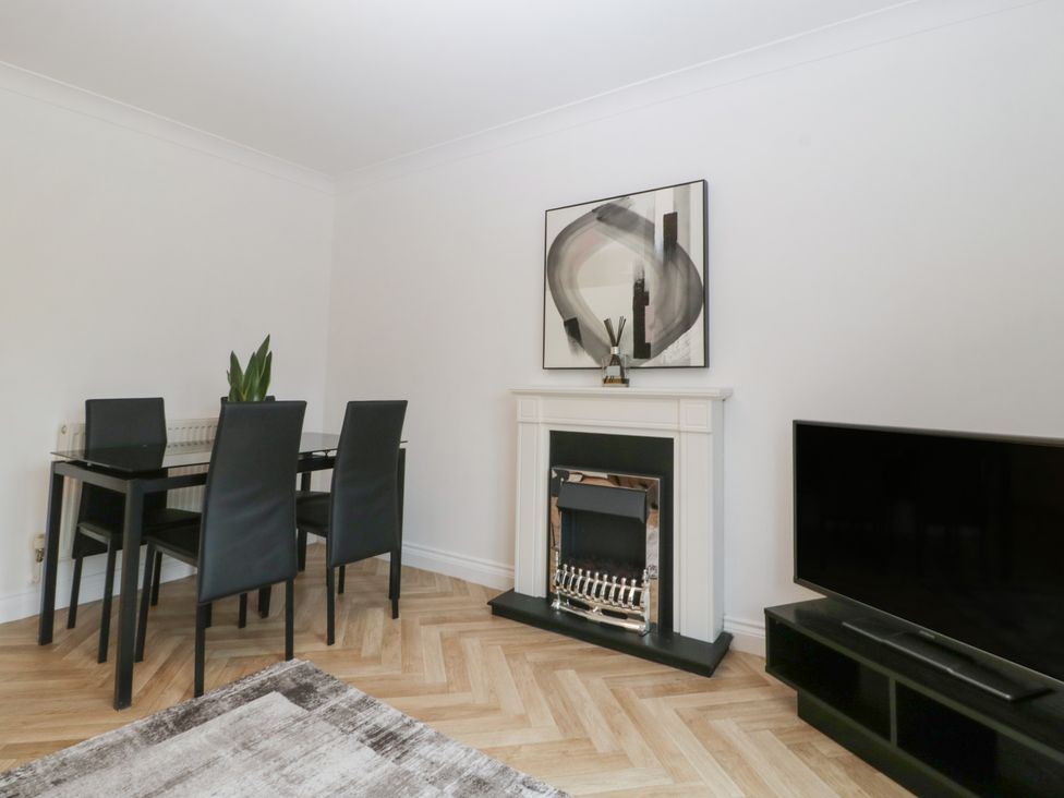 A living room with a dining area and fireplace at 42 Ynys Y Nos Glynneath