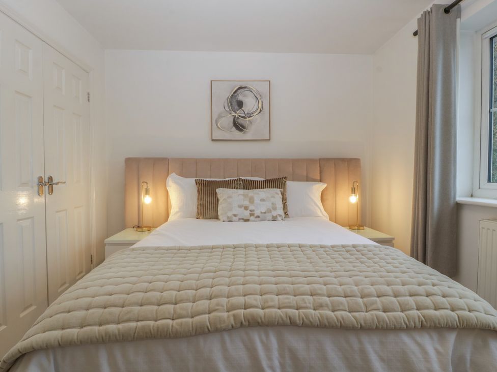 A bedroom with a bed and bedside table at 42 Ynys Y Nos in Glynneath