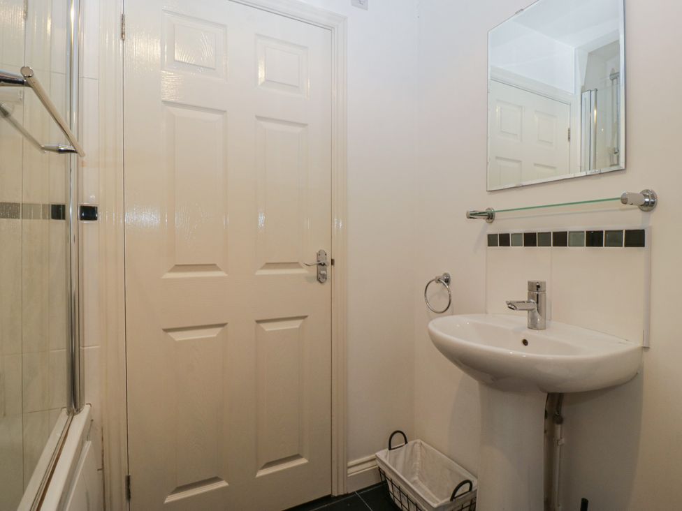 A bathroom with a sink and mirror at 42 Ynys Y Nos Glynneath