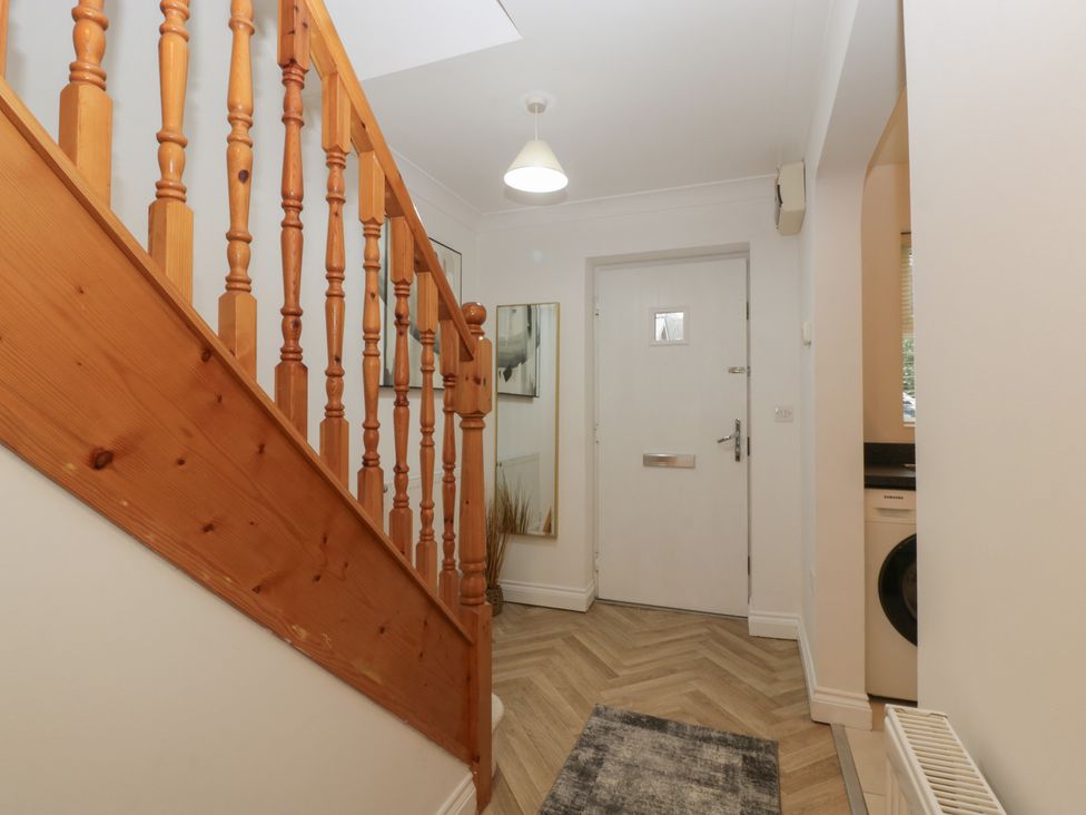 A hallway with stairs and a front door at 42 Ynys Y Nos Glynneath