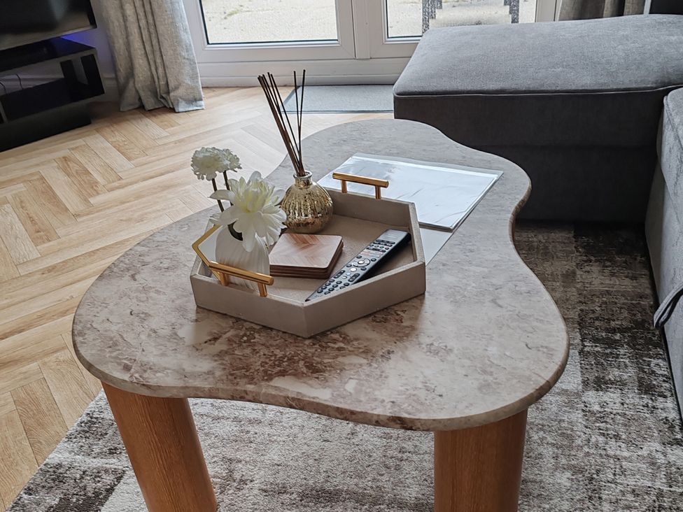 A living room with a coffee table and decor at 42 Ynys Y Nos in Glynneath