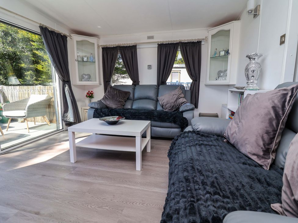 A living room with a sofa and table at Grosvenor 10 Llanarmon-Yn-Ial